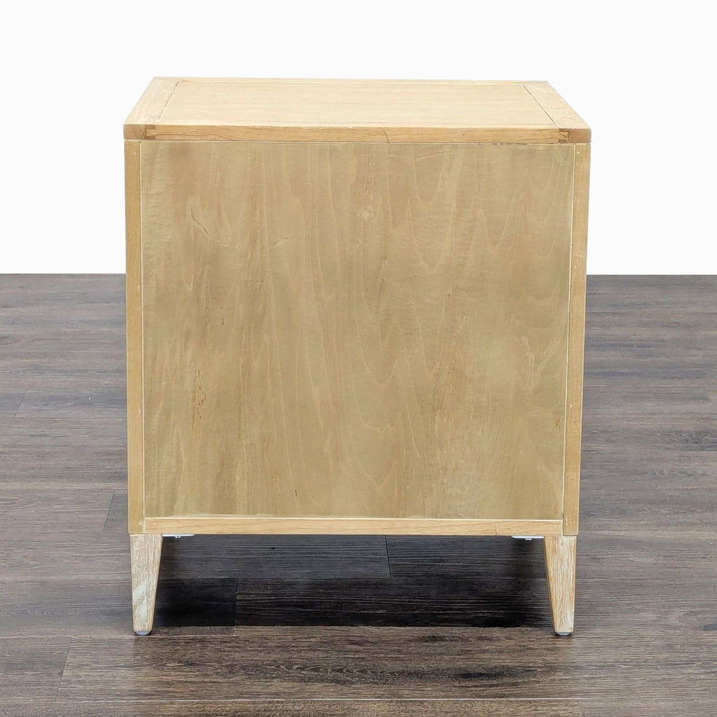 3. Back view of the Reperch end table, featuring a plain light wood panel and tapered legs.