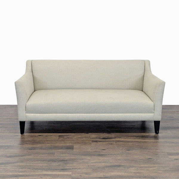 1. Front view of a beige Shenandoah Furniture loveseat with sloped arms and black legs on wood floor.