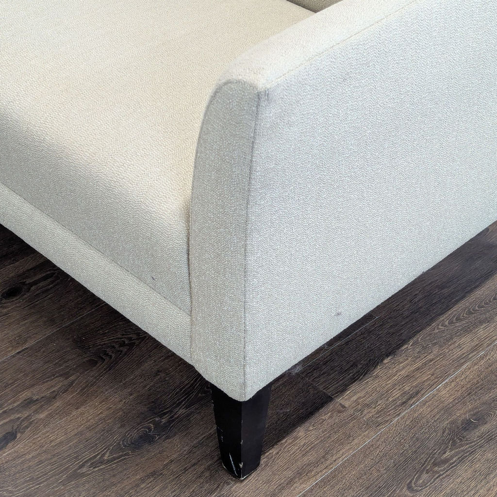 2. Close-up of the armrest and legs of a Shenandoah Furniture loveseat showing textured fabric and dark feet.