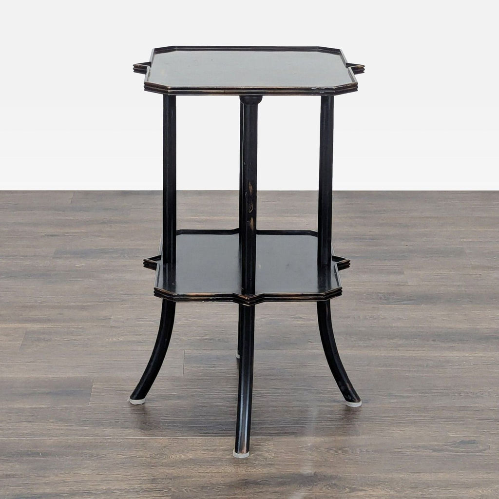 3. Elegant black Reperch side table with two hexagonal surfaces and four tapering legs, wood floor shown.