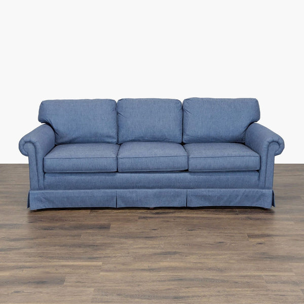 Sherrill blue 3-seat sofa with rolled arms and tailored skirt, shown from the front on wood flooring.  