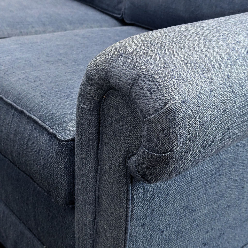 Close-up of a Sherrill 3-seat sofa arm, upholstered in textured blue fabric.  