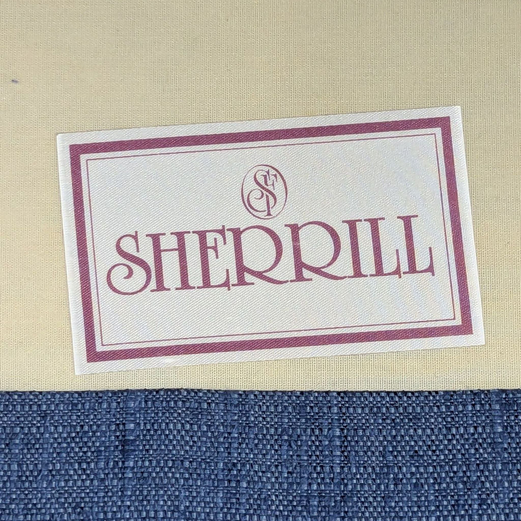 Sherrill brand label on beige and blue fabric, indicating the manufacturer of a 3-seat sofa.  