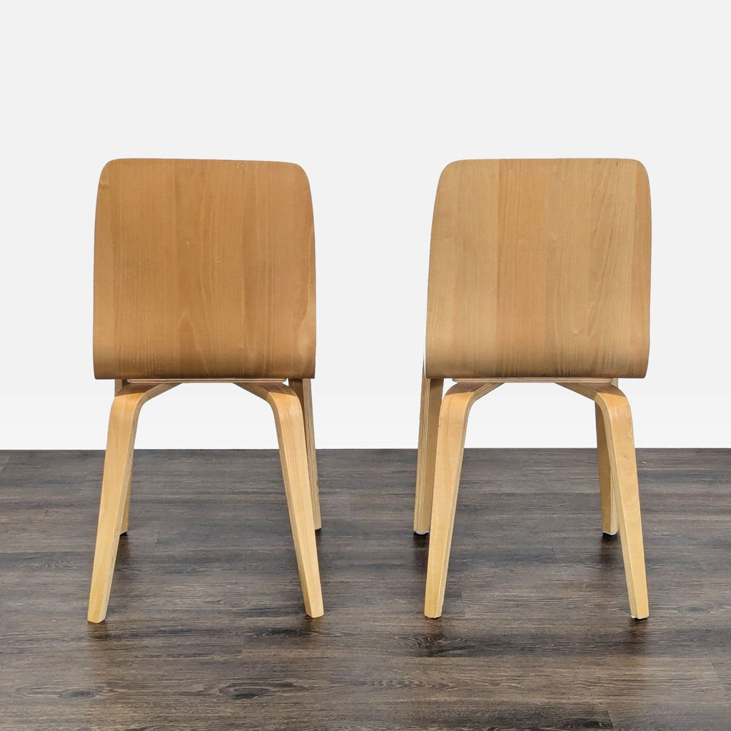 2. Back view of two Anthropologie dining chairs, clear lacquer wood finish, in the Dining Chairs category.
