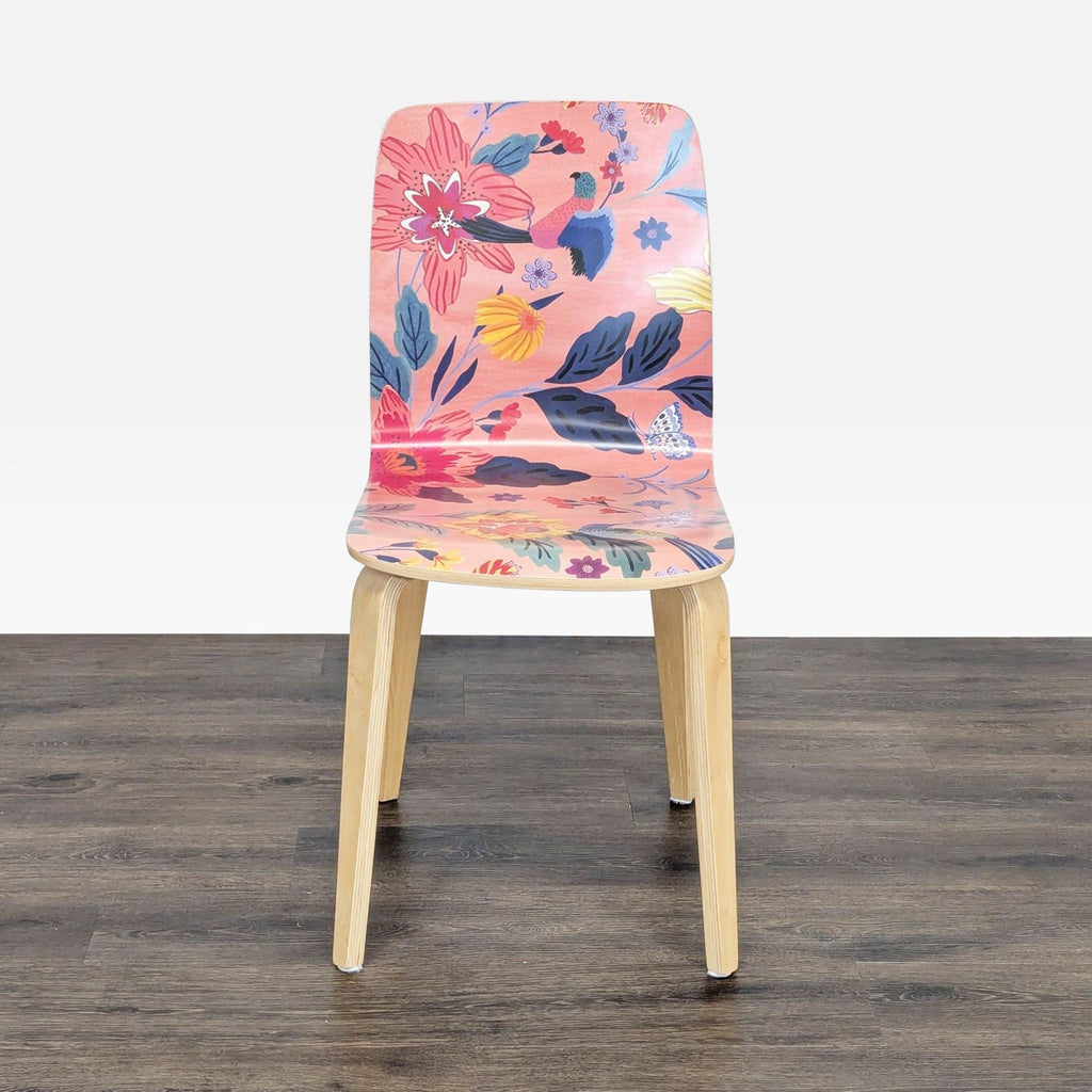 1. Front view of an Anthropologie bentwood dining chair with clear lacquer finish and a vibrant floral patterned seat.