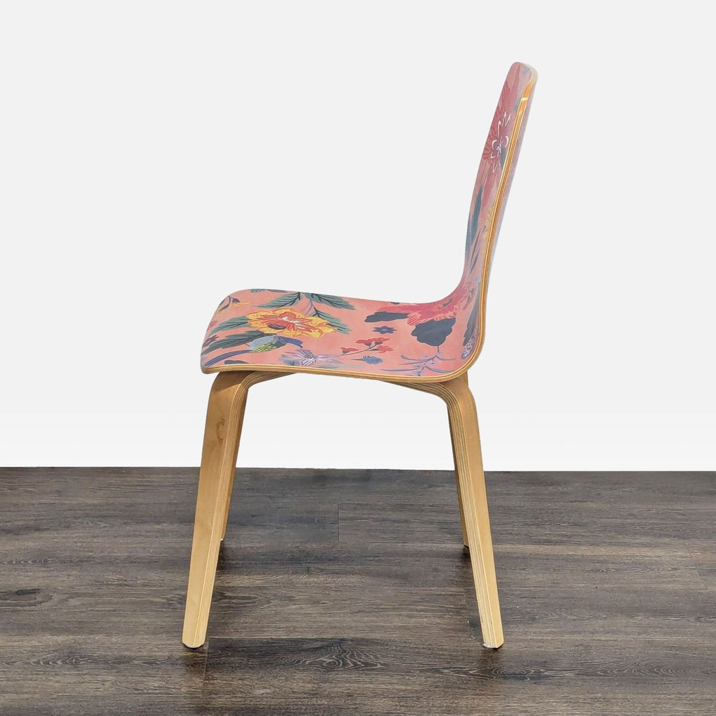 2. Side profile of a patterned bentwood dining chair by Anthropologie, featuring a smooth clear lacquer finish.