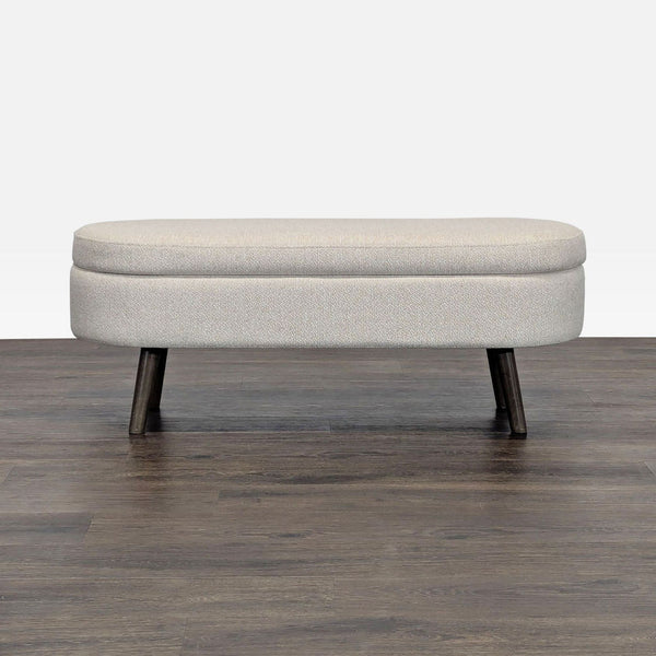 1. Modern beige upholstered bench ottoman from Walmart with dark wooden legs on a wood floor, closed view.