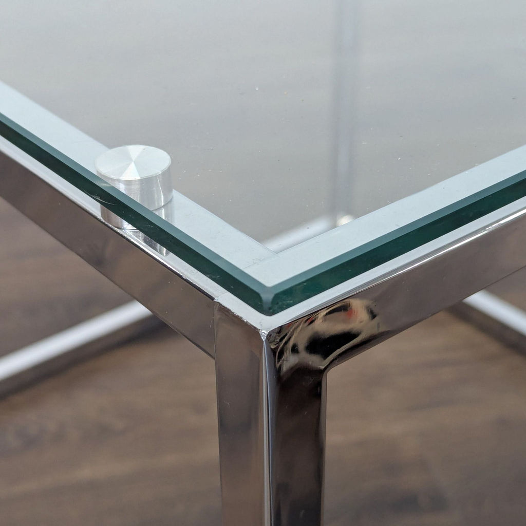 1. Close-up of a Reperch end table with a glass top and chrome frame, highlighting the corner detail.  