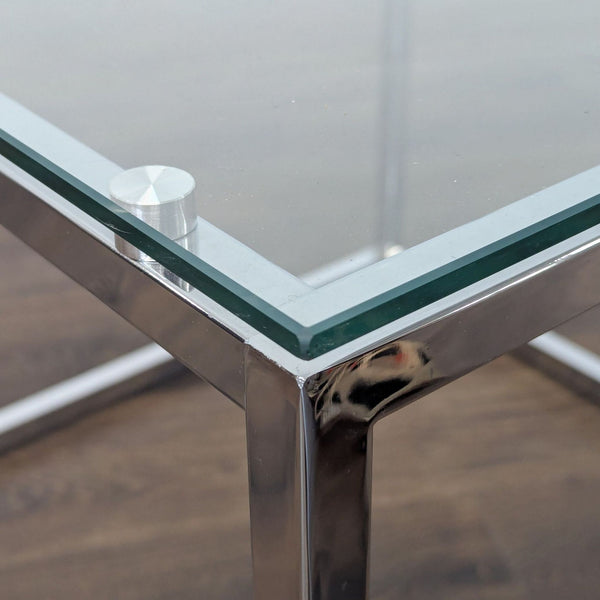 1. Close-up of a Reperch end table with a glass top and chrome frame, highlighting the corner detail.  