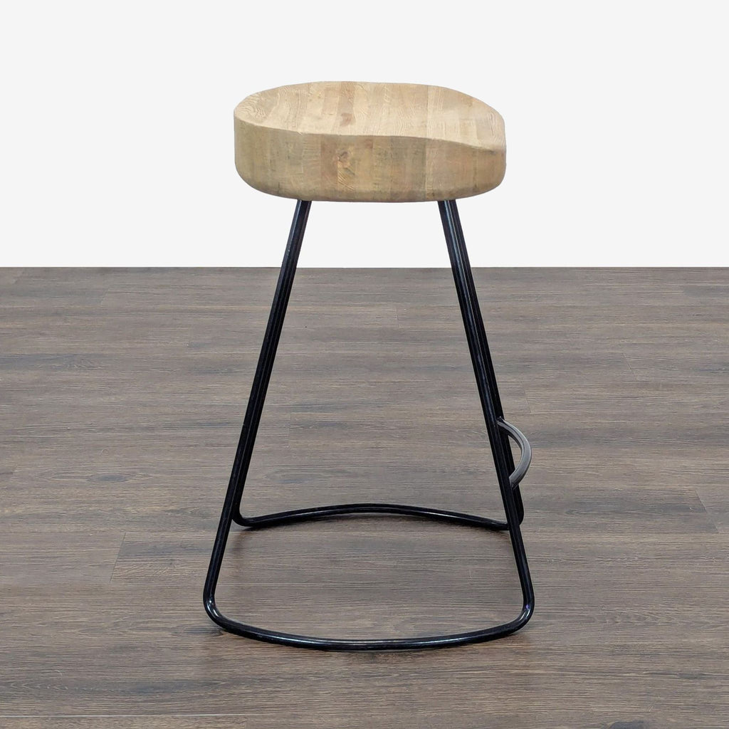 2. Modern stool with a thick wood seat and minimalist black metal legs, displayed on a wood floor.