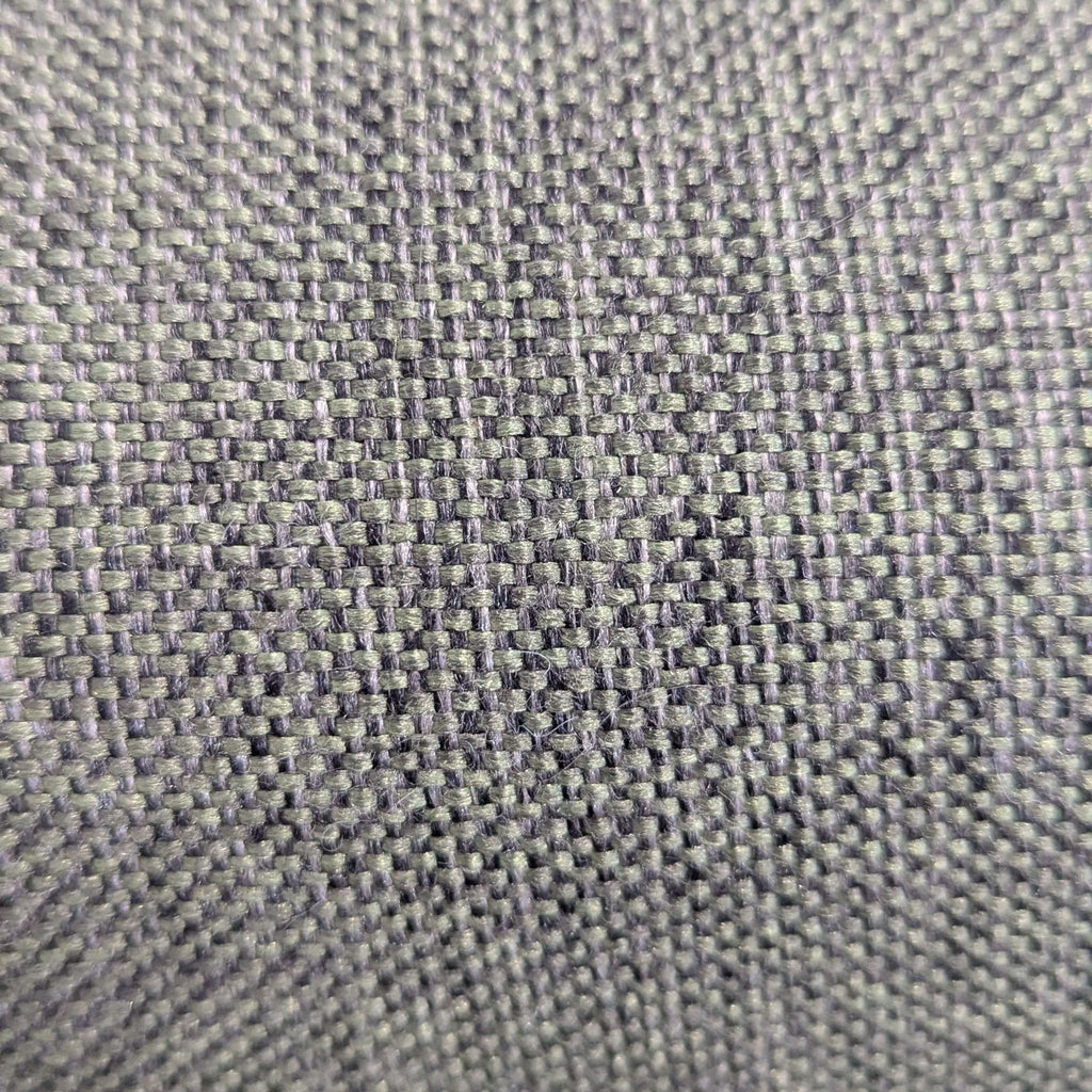 2. Detailed macro shot of the green woven fabric texture from a Burrow sectional sofa.  