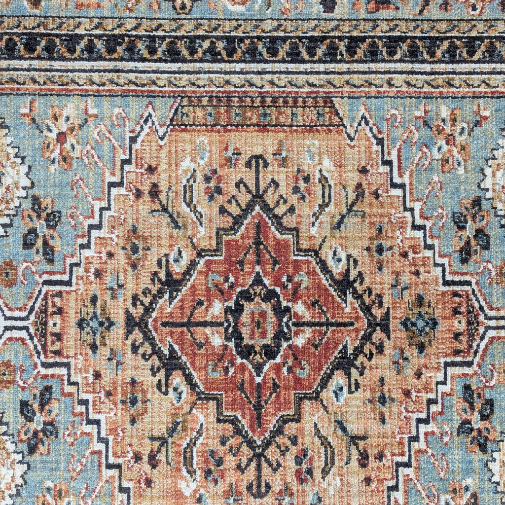 2. Close-up of Reperch rug’s detailed medallion pattern in warm rust, beige, and blue tones.
