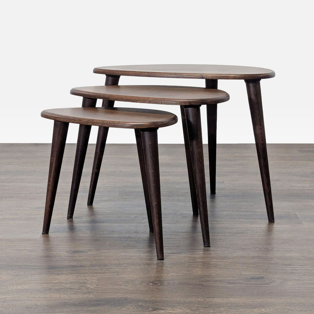 1. Set of three Reperch side tables in good condition, dark wood finish, nested on wood flooring.