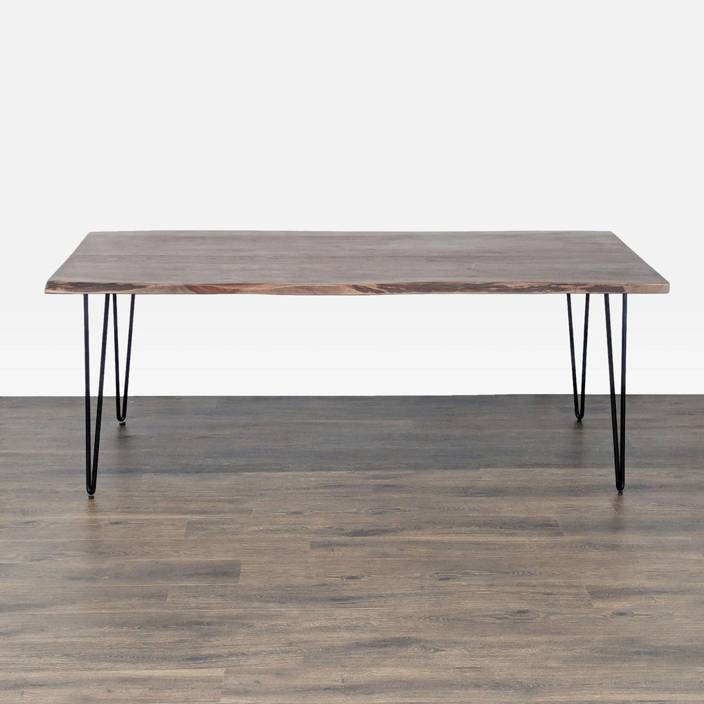 Reperch dining table with metal hairpin legs and a natural wood top, shown in a minimalist setting.