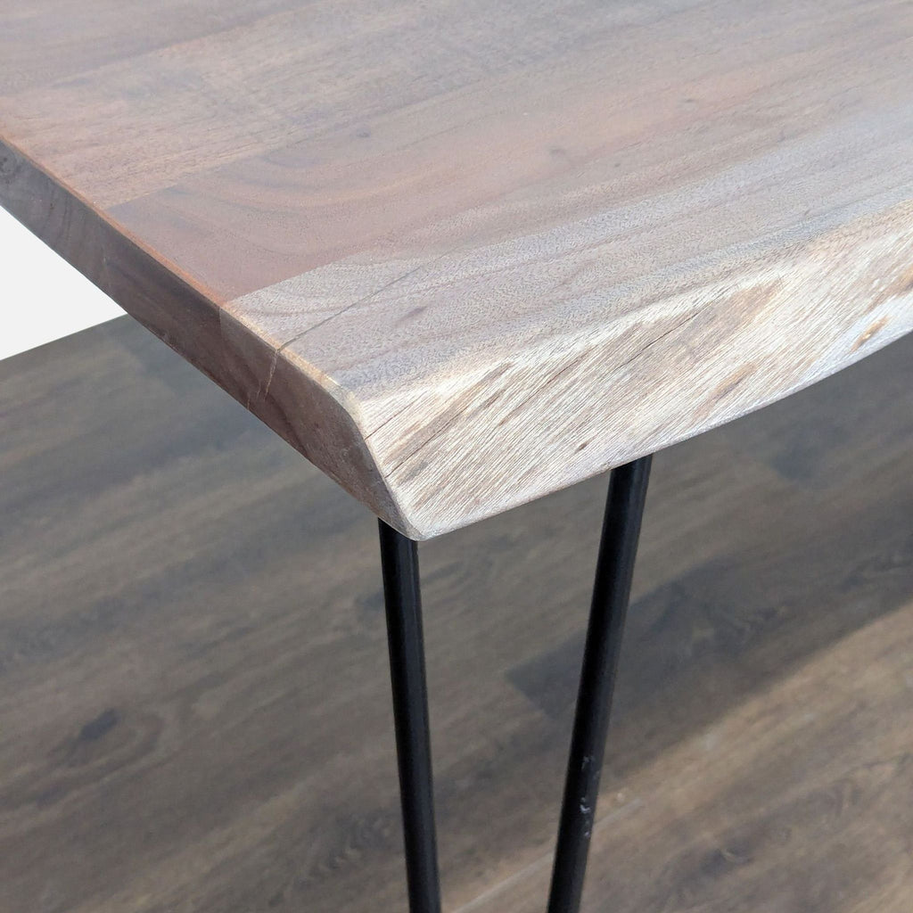 Close-up of a Reperch dining table corner, highlighting the wood grain and metal hairpin legs.