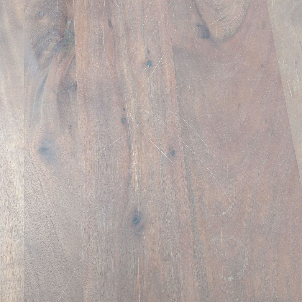 Detailed view of the Reperch dining table’s wooden surface, featuring visible grain and light scratches.