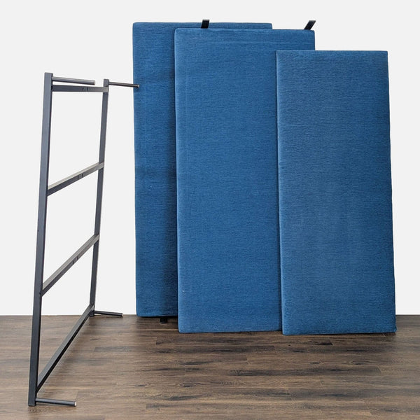 1. Room & Board headboard with three blue upholstered panels and a sturdy black metal frame, ideal for bedroom decor.