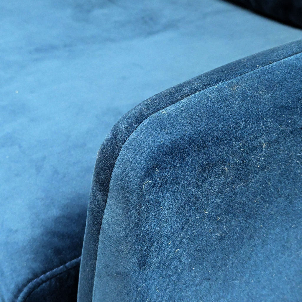 Close-up of soft blue velvet upholstery on an Edloe Finch lounge furniture piece, showing texture detail.