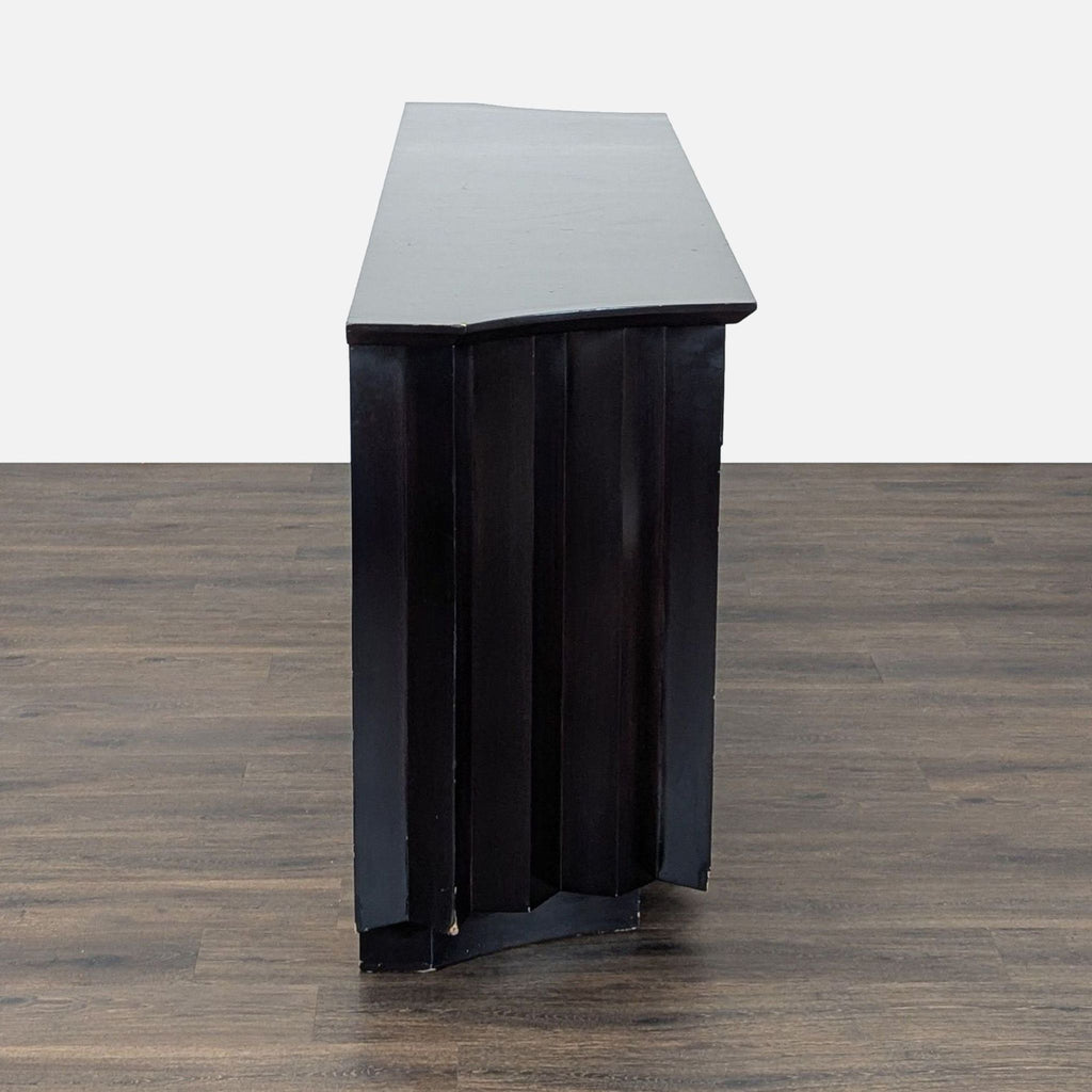 2. Side profile of a Derepage Design black credenza, highlighting its angular, textured design.  