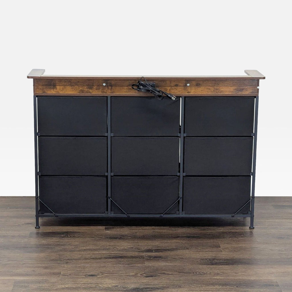 1. Front view of a Reperch sideboard with a wood top and nine black fabric drawers on a metal frame.