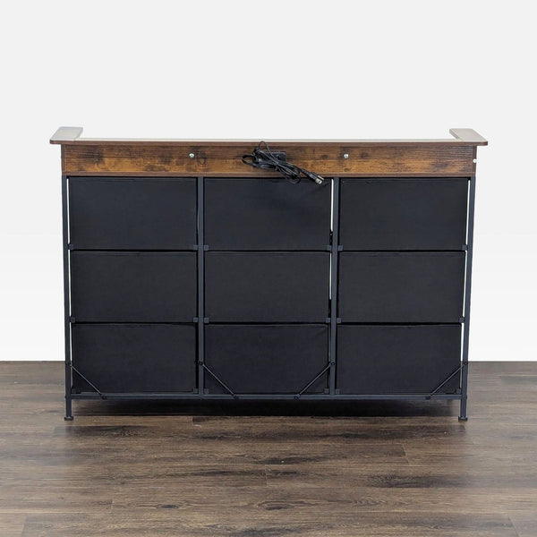 1. Front view of a Reperch sideboard with a wood top and nine black fabric drawers on a metal frame.