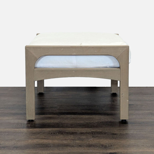 1. Pottery Barn ottoman with a light wood frame and a white cushioned top, shown on a dark wood floor.  
