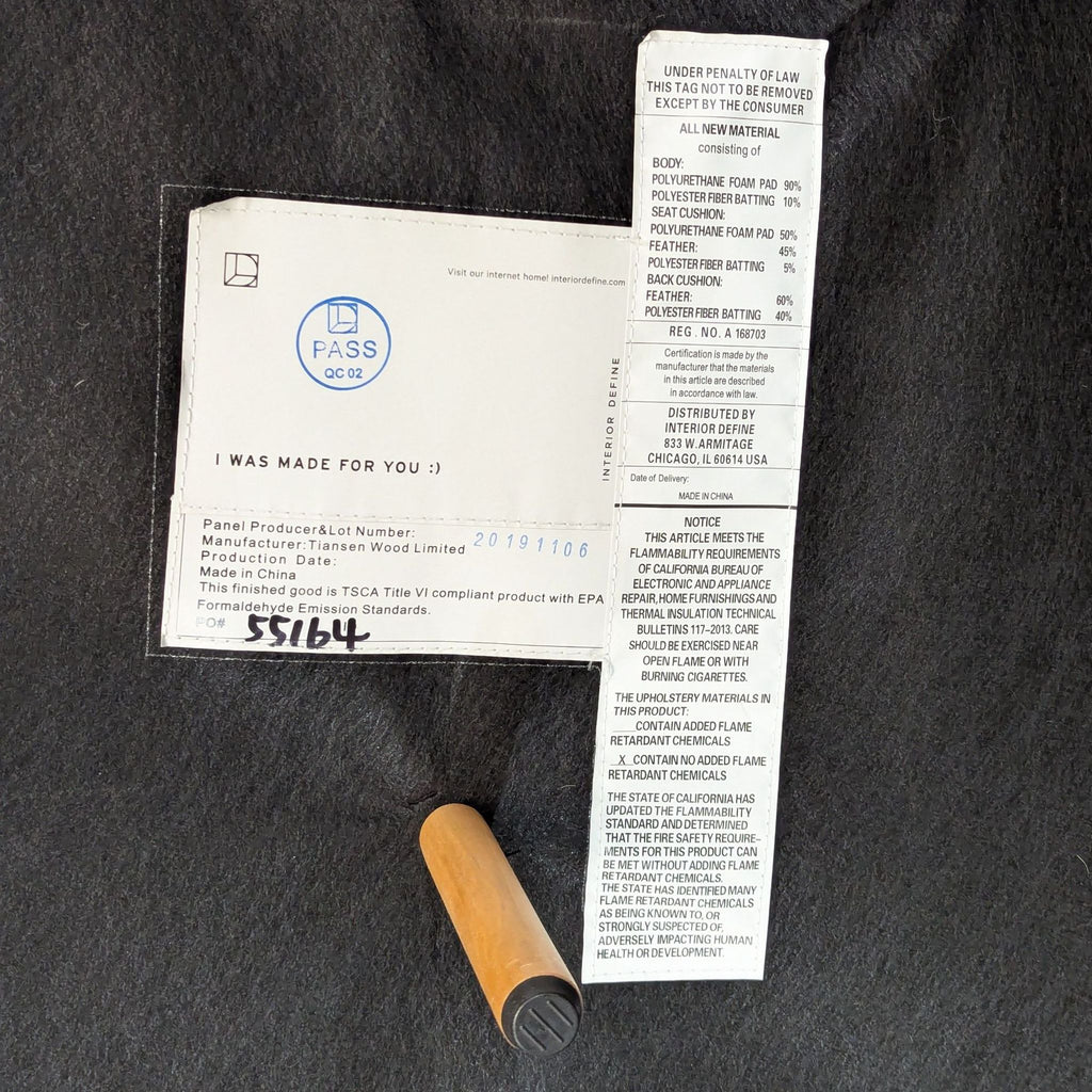 2. Manufacturer and material tags for the Interior Define Sloan sectional, showing details and wood leg.