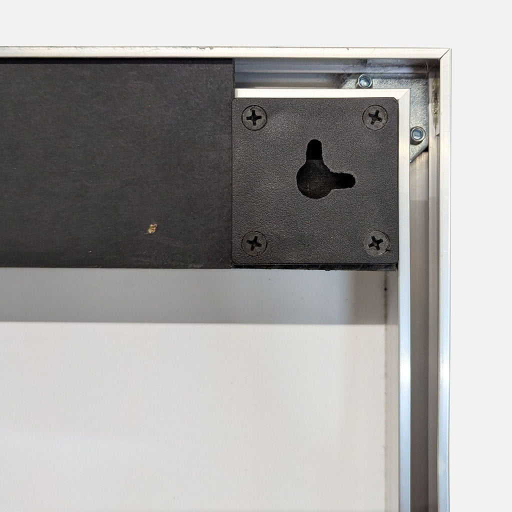 3. Backside hardware and mounting detail of a rectangular CB2 mirror with a metal frame.