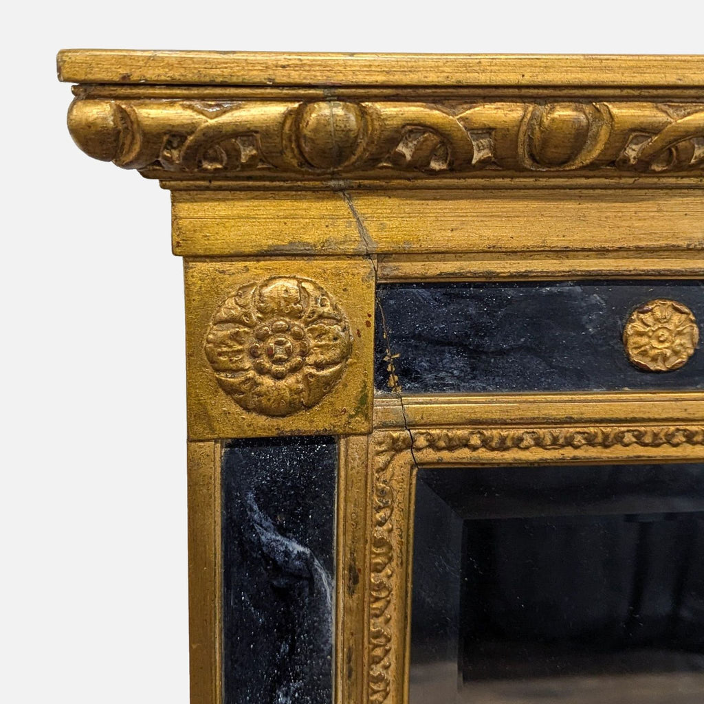 3. Decorative floral and scrollwork carvings on the upper gold and black marbleized frame of the Carvers' Guild mirror.