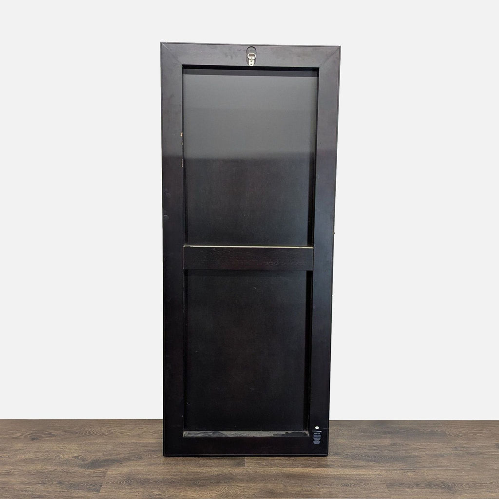 2. Back view of a West Elm rectangular mirror with a solid black frame and a wall mount hook.