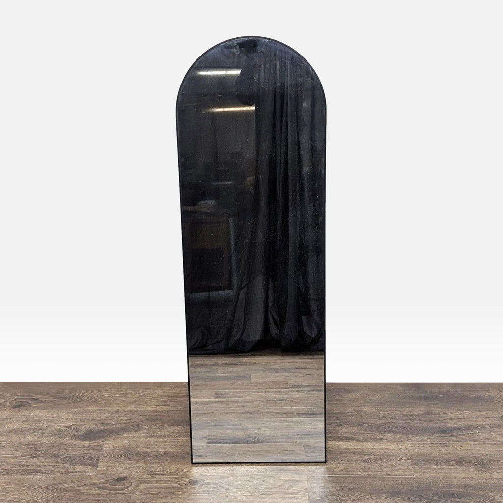 1. Reperch arched full-length mirror standing on wooden floor, reflecting a dark curtain in the background.