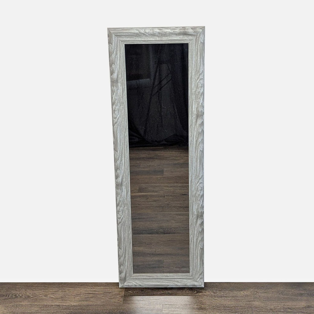 1. Tall rectangular gray woodgrain-framed MCS mirror standing on a dark wood floor against a plain wall.