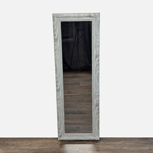 1. Tall rectangular gray woodgrain-framed MCS mirror standing on a dark wood floor against a plain wall.