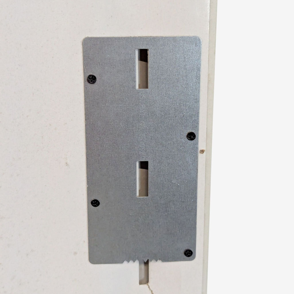 3. Detail view of the mounting hardware, showing a metal plate with screw holes on the back of the MCS mirror.