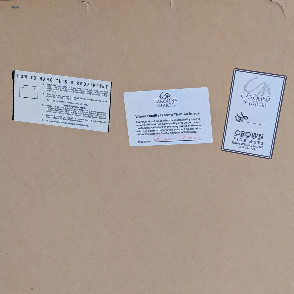 Back of a Carolina Mirror with hanging instructions, quality assurance card, and Crown Fine Arts branding.