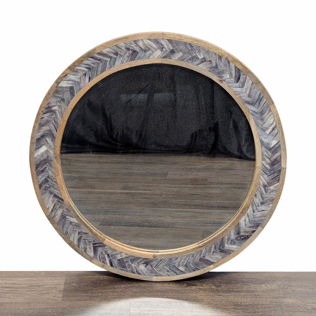 1. Round Reperch mirror with a chevron-patterned wood frame, displayed on a wooden floor, from the Mirror category.