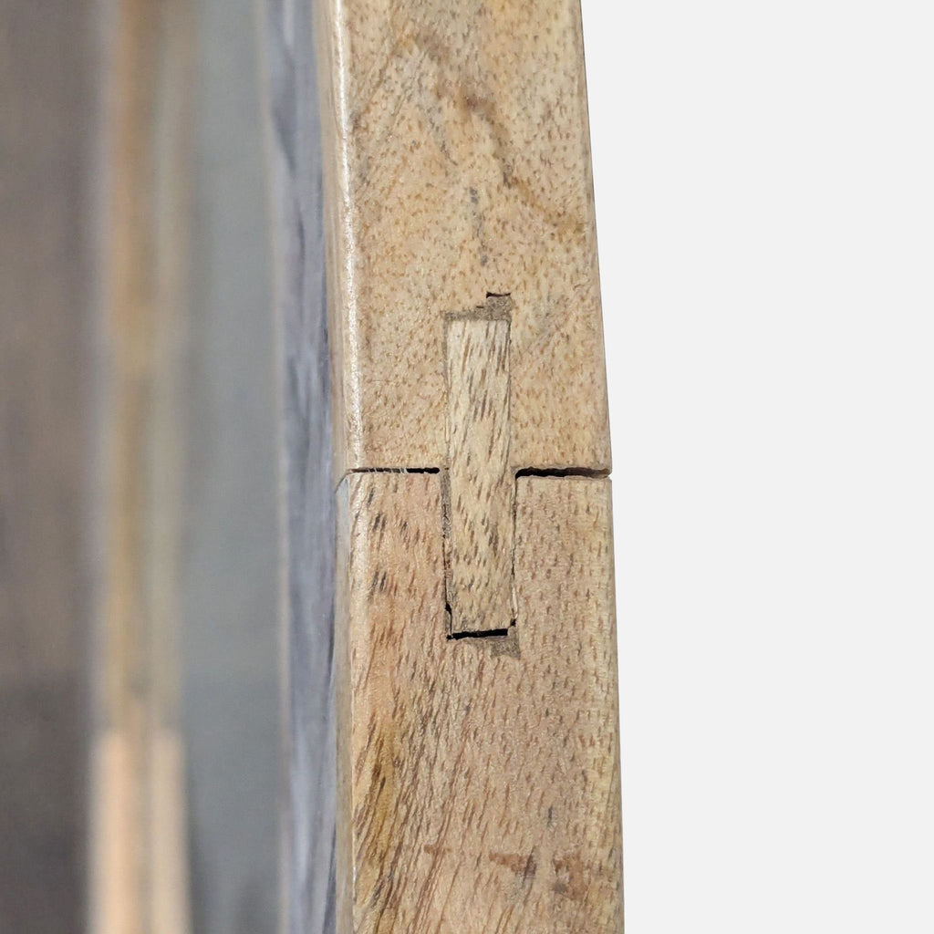 2. Close-up of the Reperch mirror's wood frame showing precise joinery and natural wood grain details.