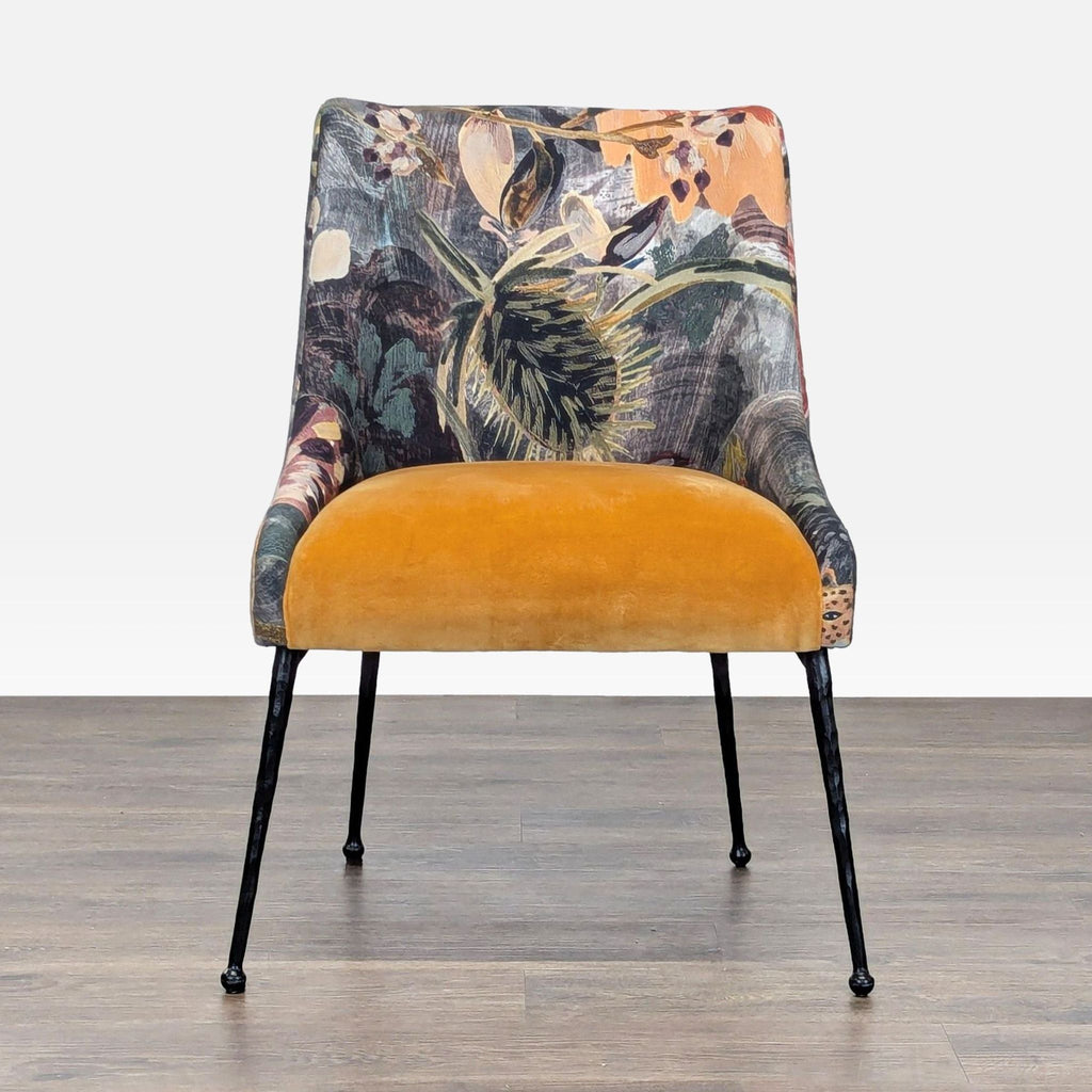 Front view of an Anthropologie lounge chair with floral and swan print, yellow velvet seat, and black legs.