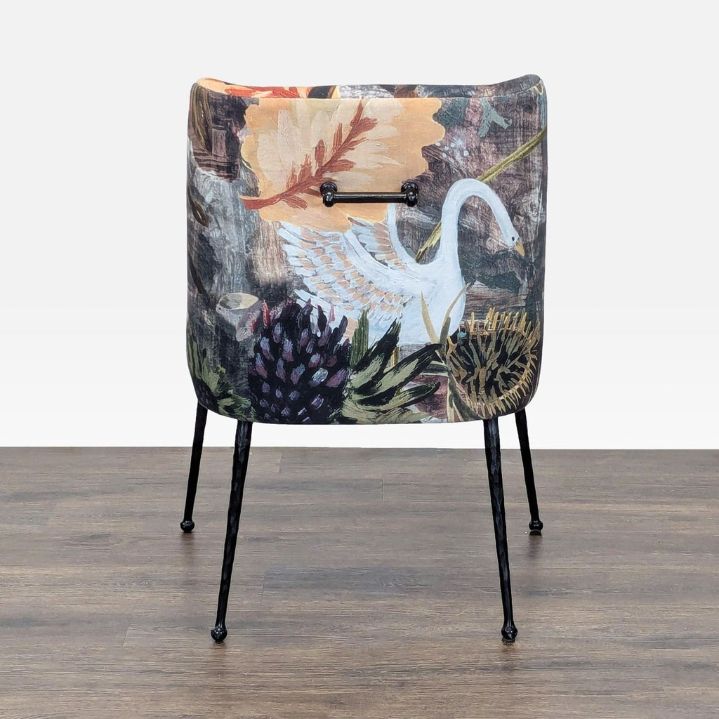 Back view of the Anthropologie lounge chair highlights the swan and floral print upholstery with sturdy black legs.