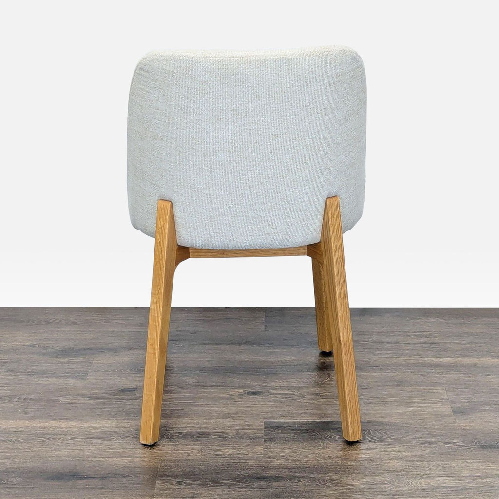 2. Rear view of Article Dining Chair showing the Camilla ivory fabric back and oak wood legs.