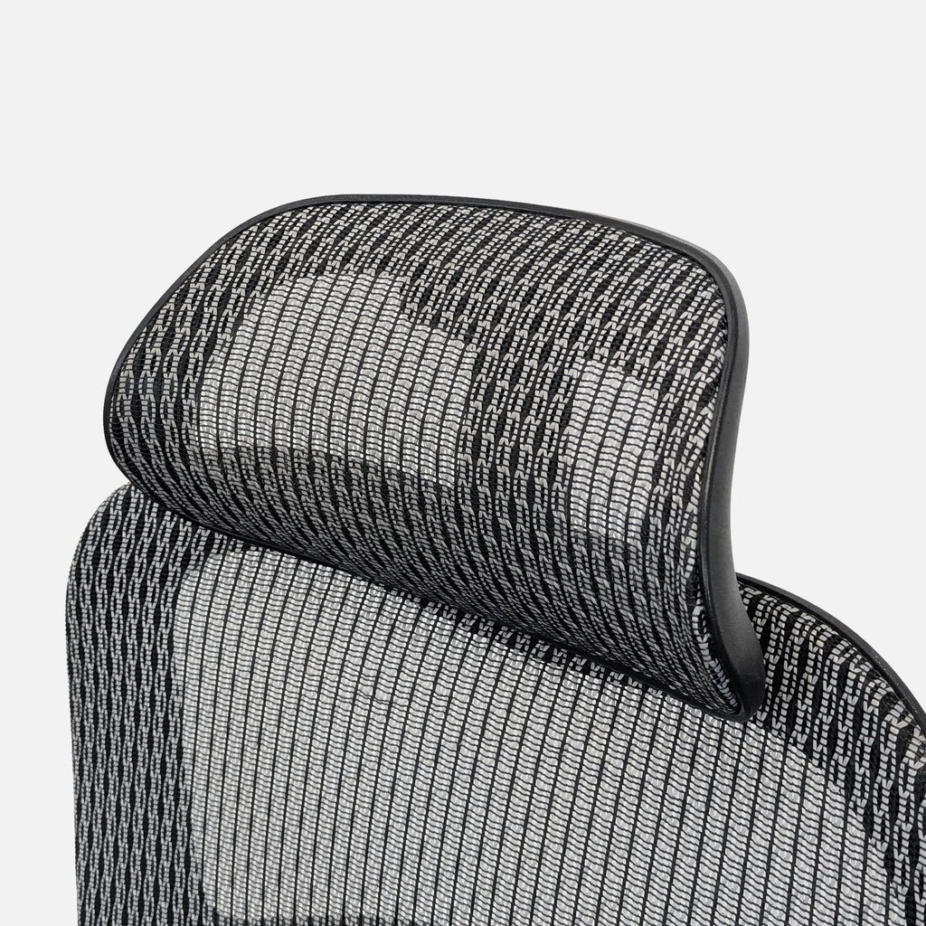 3. Detailed view of the Reperch chair headrest with breathable black-and-white mesh upholstery.