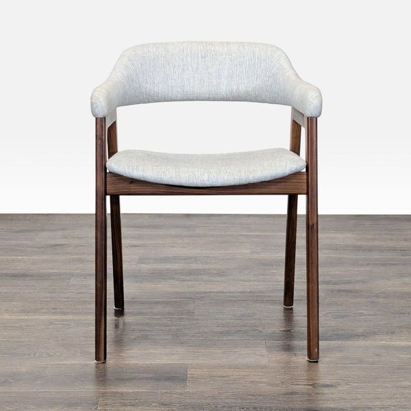 1. Front view of an Article dining chair with light gray fabric upholstery and wooden legs on a wood floor.