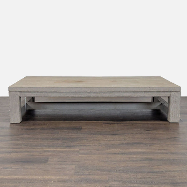 1. Rectangular Restoration Hardware coffee table in weathered wood, featuring a low profile and sturdy modern design.
