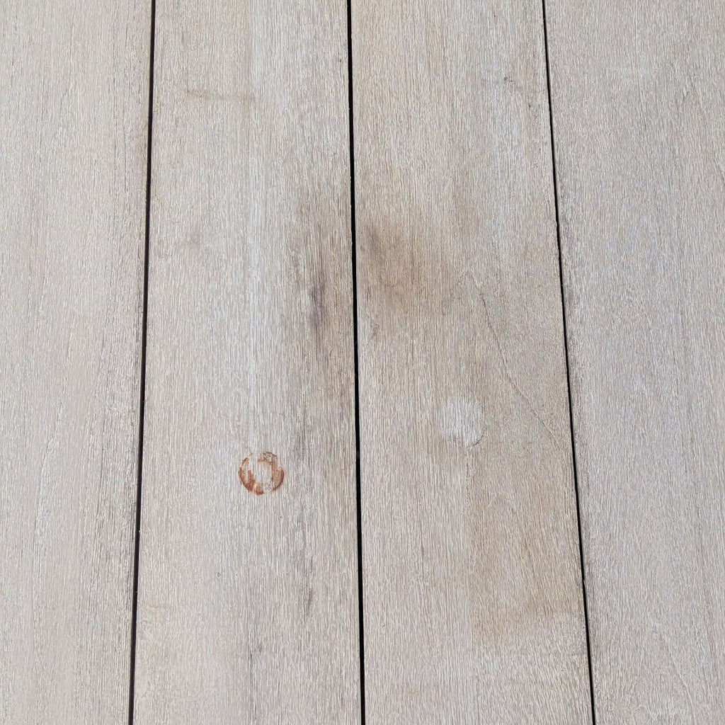 3. Detailed view of the Reperch table’s top, showing planked wood surface with natural marks and subtle imperfections.