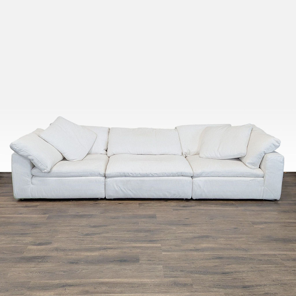 Restoration Hardware 3-seat sofa with white plush cushions and modern style, shown from the front.