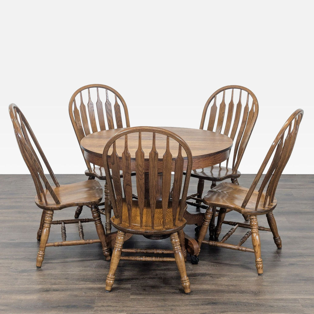 1. Classic round wooden dining set by Indian Head Table Co., with four high-back chairs on a wood floor.  