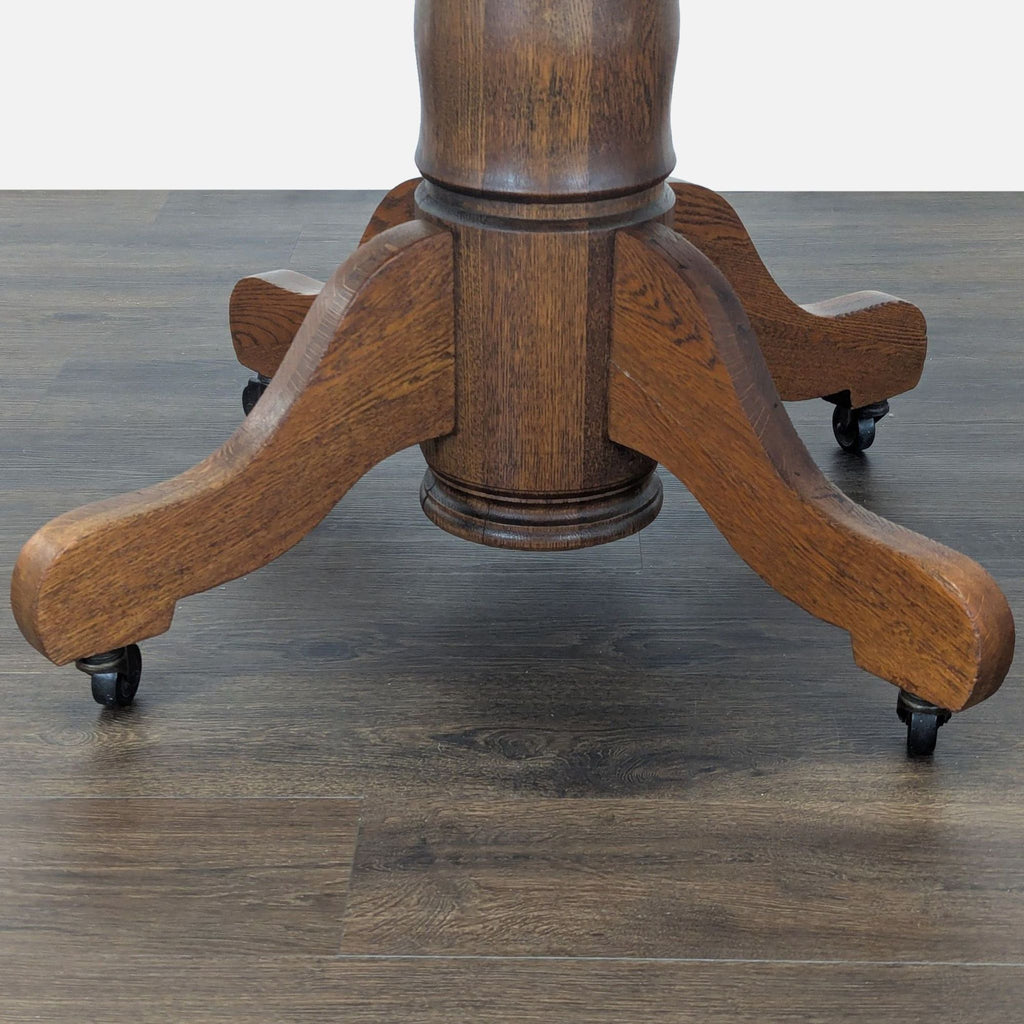 3. Detailed view of the sturdy wooden pedestal base with casters on the Indian Head Table Co. dining table.