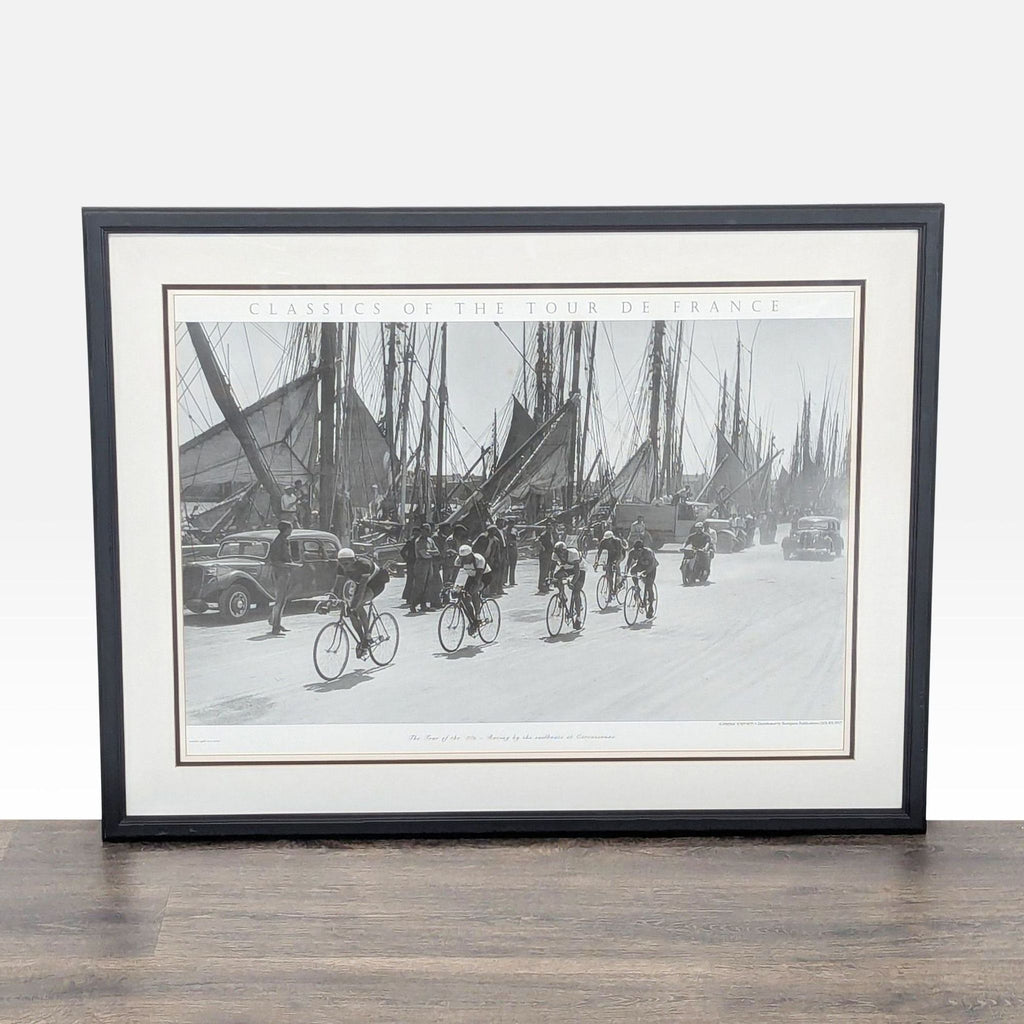 1. Framed Art.com print showing vintage cyclists racing past sailboats and old cars, black and white, Tour of the '30s.  