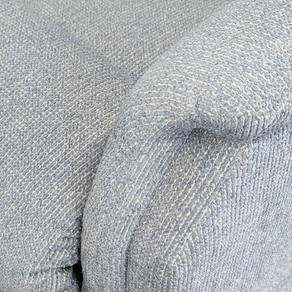 2. Close-up of La-Z-Boy lounge chair armrest in light blue textured fabric upholstery.