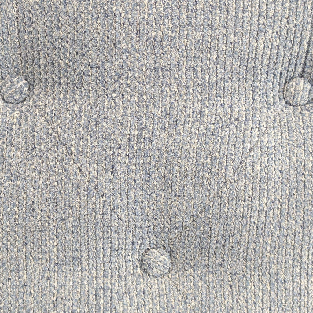 3. La-Z-Boy lounge chair backrest detail showing light blue textured fabric with tufted button accents.